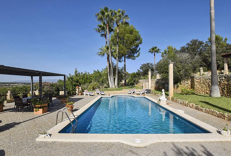 Pool mit Sonnenliegen vor dem Ferienhaus